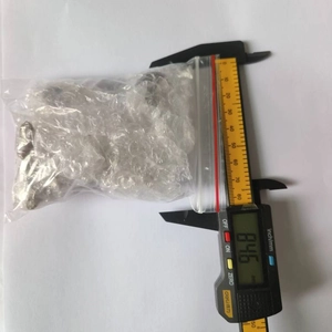 Digital caliper measuring the width of the miniature figurine packaging to show dimensions