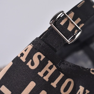 Detailed close-up of adjustable metal buckle and woven canvas strap on baseball cap