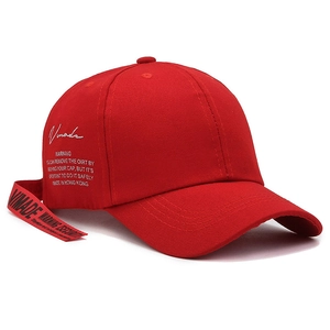 Fashionable red baseball cap with side lettering and long decorative ribbon strap