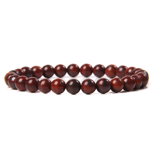 Macro detail of 6mm red agate natural stone beads with smooth polished surface and texture