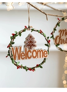 Detail of wooden Christmas wreath with Welcome carving, pine needles and red berries