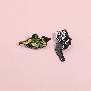 Gothic enamel pin set featuring classic swamp monster and woman with skull on pink background