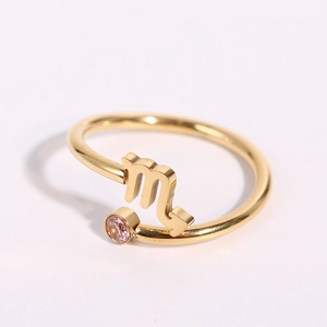 Detailed close-up of Scorpio zodiac ring in gold finish with a pink zircon gemstone