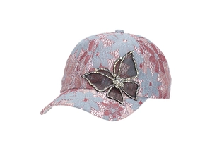 Detailed view of lace baseball cap featuring a black mesh butterfly with sparkling crystals