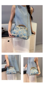 Detail view of blue satin qipao handbag with floral embroidery and wooden handle
