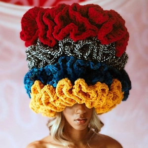 Detailed knit texture of a chunky crochet ruffle beanie with bold color blocking design