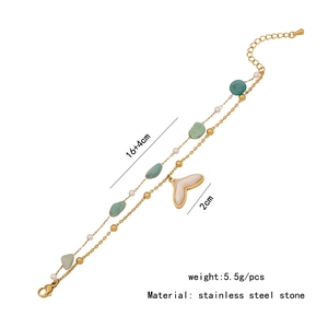 Detail view of double-layer stainless steel bracelet with green stones and pearl pendant