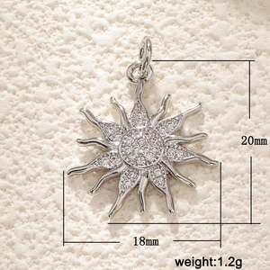 Macro shot of 18k gold plated sun pendant with sparkling zircons, 18x20mm size details