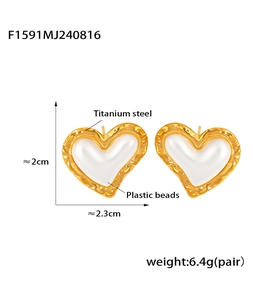 Detail of 18K gold plated titanium steel heart earrings with white plastic beads