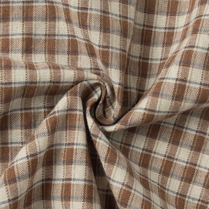 Macro shot of brown plaid fabric detail with ruffled pleats and fine textured weave