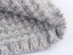 Macro view of grey knit wool fabric with subtle silver glitter and hairy texture detail