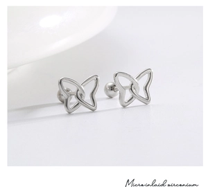 Macro shot of silver butterfly stud earrings featuring micro-inlaid zirconium stones
