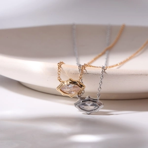 Collane con pendente a occhio in zircone oro e argento su un vassoio in ceramica raffinato