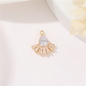 Detail of 14k gold-plated cherry pendant with pear-shaped zircon and fan-shaped baguettes