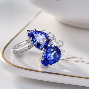 Detailed view of pear-shaped blue sapphire teardrop ring with double stones in silver