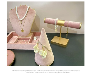 Pink velvet jewelry display set featuring necklace stands, trays and bracelet holders