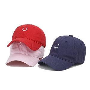 Kids' cotton baseball cap with embroidered smiley face in red, pink, and navy blue colors
