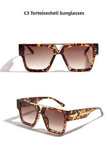Close-up of tortoise square sunglasses with golden heart detail and V-shaped metal bridge