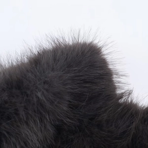 Macro shot of high-density faux fur material in dark grey color for women short coat