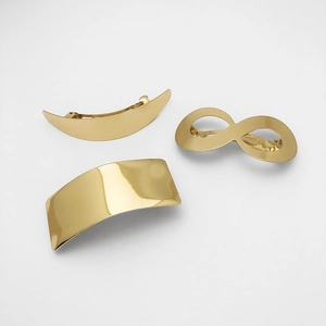 Three-piece gold metal hair clip set featuring crescent, infinity, and rectangular shapes