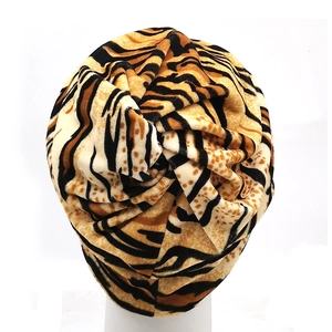 Detail of zebra and leopard animal print turban hat with a twisted top design
