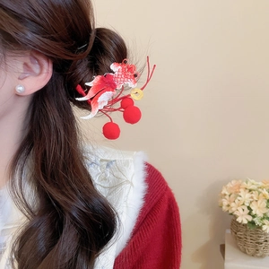 Detailed view of Chinese style goldfish hair clip with red embroidery and pearl tassels