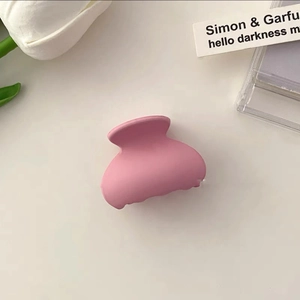 Pink matte cloud hair claw clip for side bangs displayed with elegant tulip aesthetics