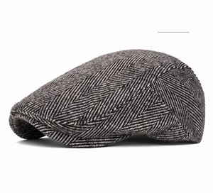 Detailed close-up of grey herringbone weave texture on a retro newsboy cap