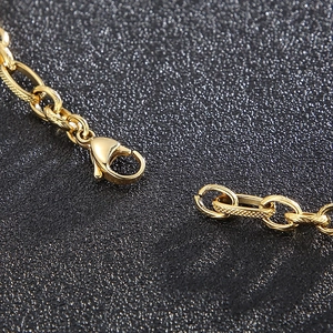 Macro shot of gold-plated titanium steel necklace with lobster clasp and textured links