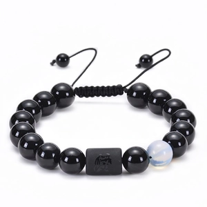 Detailed shot of adjustable Aquarius zodiac bracelet with black agate beads and engraving