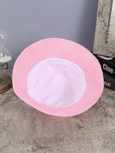 Detailed interior view of pink rhinestone bucket hat showing white lining and structure