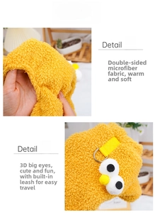 Detail of yellow fleece pet clothes featuring 3D eyes and a sturdy metal D-ring leash clip