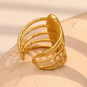 Detailed macro view of multi-layered hollow gold-plated stainless steel ring with hammered texture