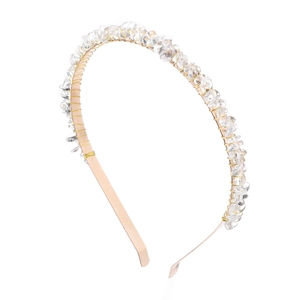 Detailed view of handmade gold wire-wrapped headband with natural transparent crystal stones
