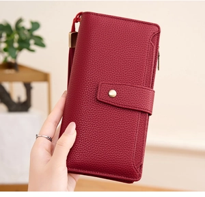 Close-up of wine red lychee pattern long wallet with RFID protection and wrist strap