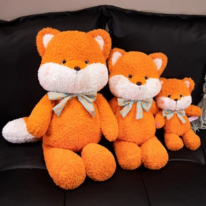 Cute orange and white fox plush set with plaid bows on a premium leather seat
