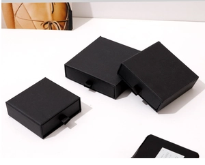 Detail view of square black drawer jewelry box with silk pull string and matte finish