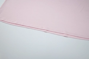 Close-up of pink dress hem showcasing double-stitch sewing and high-quality fabric texture