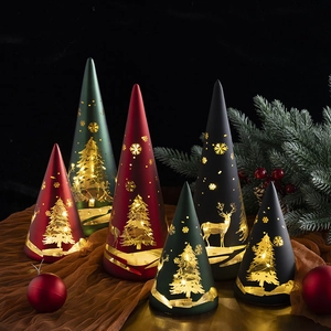 Conical Christmas lanterns with glowing reindeer and tree patterns for holiday decor