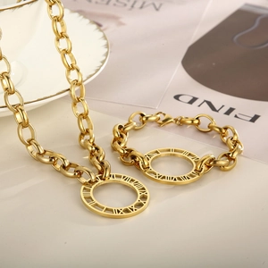 Macro shot of gold Roman numeral pendant necklace and bracelet set on a magazine background
