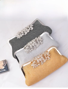 Detailed view of luxury evening clutch bags in gold, silver, and black with sparkling rhinestones