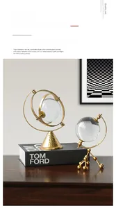 Detail of luxury crystal balls with gold cone and tripod metal bases on wood