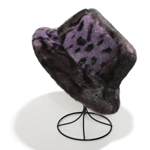 Deep purple leopard print faux fur bucket hat displayed on a modern black stand