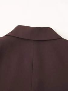Macro shot of back collar construction and fine fabric texture on brown blazer
