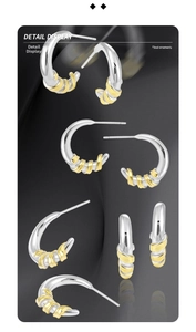 Detail view of S925 silver C-shape earrings featuring golden spiral texture contrast