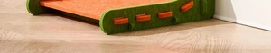 Detail of L-shaped cat scratcher featuring vibrant orange felt and green interlocking side panels