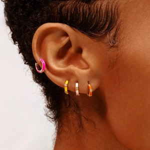 Close-up of colorful enamel bamboo hoop earrings with micro-set zircon on model ear