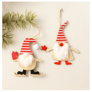 Close-up of wooden Santa Gnomes hanging ornaments with pine branches and warm lighting