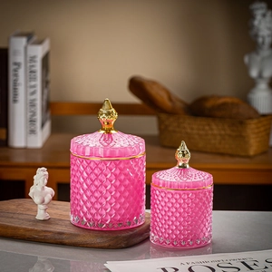Pink diamond-textured glass storage jars with golden lids and home decor accents