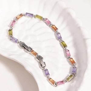 Rainbow zirconia bracelet in 18K gold plating on a shell texture display tray